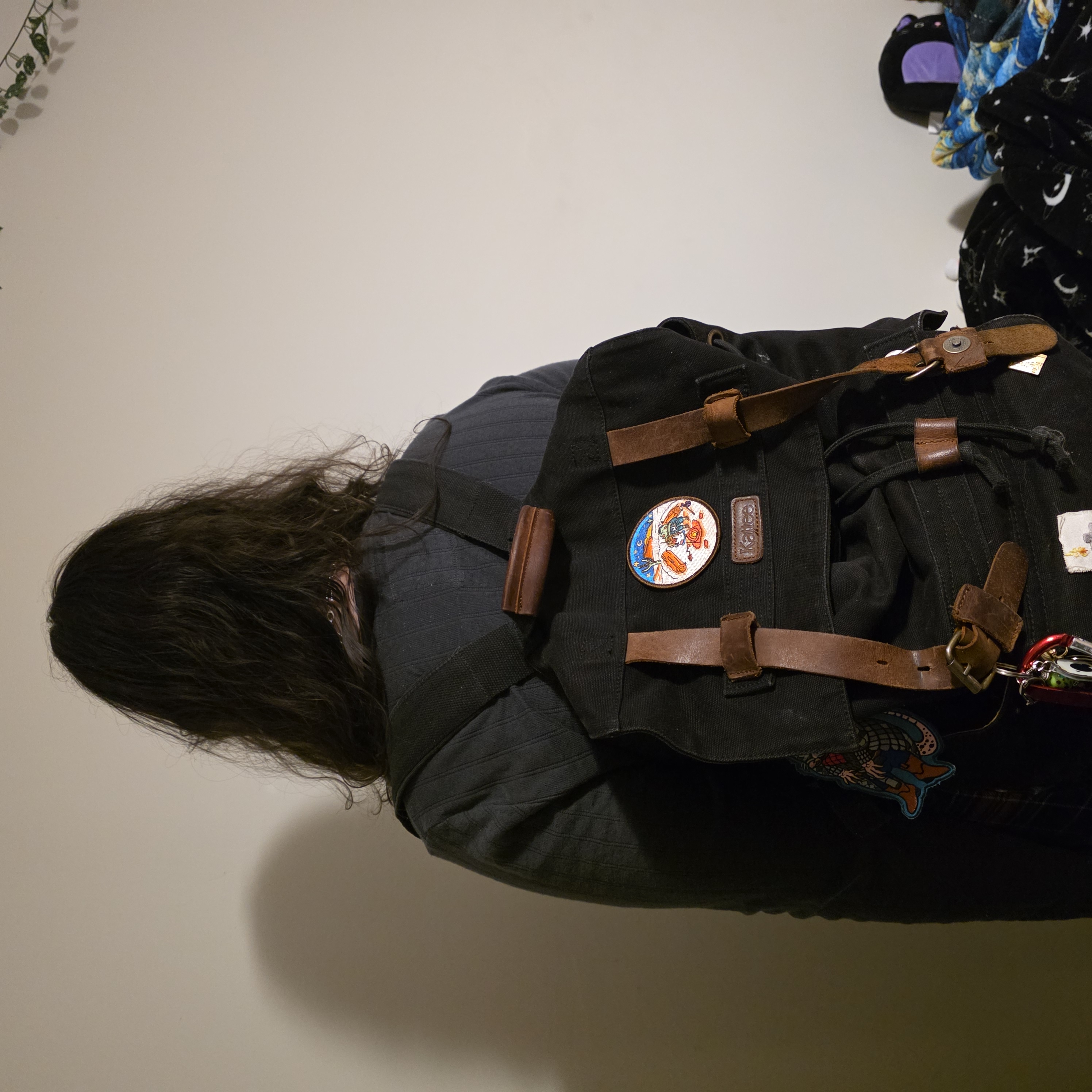 Putting on a backpack is a wearable interaction because it is a full-body interaction involving arms and adjusting the shoulder to use.